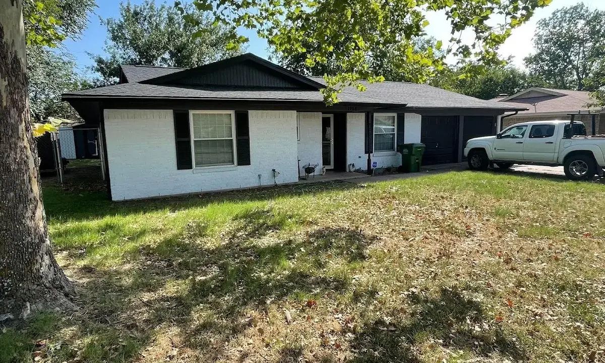 Professional roofing crew working on a residential roof in Carl Junction